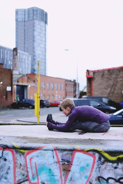 Helen doing a forward bend in Liverpool city Centre